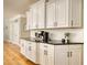 Bright kitchen featuring white cabinets, granite counters, subway tile backsplash, and hardwood floors at 4777 Ardmore Ln, Hoschton, GA 30548