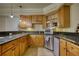 A stylish kitchen featuring granite countertops, stainless steel appliances and sleek wooden cabinets at 4777 Ardmore Ln, Hoschton, GA 30548