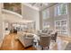 Spacious living room with high ceilings, fireplace, hardwood floors, and an open layout to the kitchen at 4777 Ardmore Ln, Hoschton, GA 30548