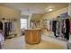 Large walk-in closet with built-in shelving and a center island for storage at 4777 Ardmore Ln, Hoschton, GA 30548