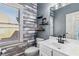 Charming bathroom with wood accent wall, modern fixtures, and a bright window at 1142 Hidden Spirit Trl, Lawrenceville, GA 30045