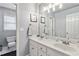 Bathroom featuring double sinks, a toilet, a large mirror, and neutral gray walls at 1142 Hidden Spirit Trl, Lawrenceville, GA 30045