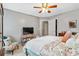 Bedroom featuring a bed with patterned pillows, a ceiling fan, and a cushioned chair at 1142 Hidden Spirit Trl, Lawrenceville, GA 30045