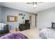Large bedroom featuring a bed, beanbag chair, desk area and dark colored furnishings at 1142 Hidden Spirit Trl, Lawrenceville, GA 30045