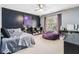 Stylish bedroom features a starry night accent wall, modern lighting, and a comfortable purple beanbag chair at 1142 Hidden Spirit Trl, Lawrenceville, GA 30045