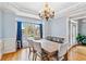 Charming dining room with hardwood floors, large window, chandelier, and elegant trim at 1142 Hidden Spirit Trl, Lawrenceville, GA 30045