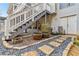 Landscaped backyard with stone pathway and stairs leading to the deck and basement entrance at 1142 Hidden Spirit Trl, Lawrenceville, GA 30045