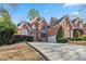 Beautiful brick home featuring manicured lawns and a curved driveway at 1142 Hidden Spirit Trl, Lawrenceville, GA 30045
