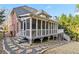 Backyard showcasing the house exterior with a deck, sunroom, and landscaped yard at 1142 Hidden Spirit Trl, Lawrenceville, GA 30045