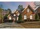 Charming brick home with manicured landscaping with twilight sky background at 1142 Hidden Spirit Trl, Lawrenceville, GA 30045