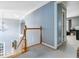 Hallway with a view of the staircase and entryway featuring light blue walls and neutral carpeting at 1142 Hidden Spirit Trl, Lawrenceville, GA 30045