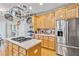 Updated kitchen featuring stainless appliances, gas cooktop island, and light wood cabinetry at 1142 Hidden Spirit Trl, Lawrenceville, GA 30045