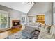 Cozy living room with a fireplace, hardwood floors, and plenty of natural light at 1142 Hidden Spirit Trl, Lawrenceville, GA 30045