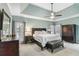 Comfortable main bedroom features a tray ceiling, carpet, and neutral paint at 1142 Hidden Spirit Trl, Lawrenceville, GA 30045