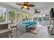 Cozy screened porch with comfortable seating, ceiling fans, and views of the backyard at 1142 Hidden Spirit Trl, Lawrenceville, GA 30045
