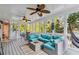 Cozy sunroom with lots of natural light, ceiling fans, and comfortable wicker seating at 1142 Hidden Spirit Trl, Lawrenceville, GA 30045
