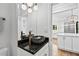 Modern bathroom vanity with granite countertop, stylish fixtures, and unique stone vessel sink at 53 Paces West Nw Dr, Atlanta, GA 30327