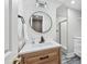 Bathroom features modern vanity, a sleek round mirror, and a glass-enclosed shower, offering a stylish and functional space at 53 Paces West Nw Dr, Atlanta, GA 30327