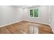 Bedroom featuring hardwood floors, a large window, and fresh white paint at 53 Paces West Nw Dr, Atlanta, GA 30327