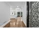 Elegant foyer showcasing hardwood floors, decorative front door, and view into the kitchen at 53 Paces West Nw Dr, Atlanta, GA 30327