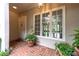 Inviting front porch with brick flooring, potted plants, and a view into the home at 53 Paces West Nw Dr, Atlanta, GA 30327