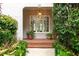 Charming front porch with brick flooring, potted plants, and a welcoming entrance at 53 Paces West Nw Dr, Atlanta, GA 30327