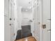 Hallway features polished dark tile floors, white trim, and doors with brass hardware at 53 Paces West Nw Dr, Atlanta, GA 30327