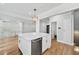 A large kitchen island with stainless appliances, pendant lighting, and a view to the living room at 53 Paces West Nw Dr, Atlanta, GA 30327