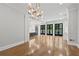 Bright living room features hardwood floors, crown molding, and french doors to a deck at 53 Paces West Nw Dr, Atlanta, GA 30327