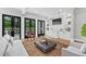 Bright living room with built-in bar, dark french doors, and light hardwood floors at 53 Paces West Nw Dr, Atlanta, GA 30327