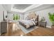 Bright main bedroom featuring a tray ceiling, hardwood floors, and a large window at 53 Paces West Nw Dr, Atlanta, GA 30327