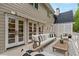 Relaxing outdoor patio with comfortable seating, awning, and views of the lush backyard at 53 Paces West Nw Dr, Atlanta, GA 30327