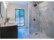Modern bathroom featuring double sinks, a glass-enclosed shower, and a large window with backyard view at 541 Earlvine Nw Way, Kennesaw, GA 30152