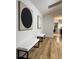 Hallway showcasing hardwood floors, modern art, and seating benches at 541 Earlvine Nw Way, Kennesaw, GA 30152