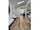 Bright hallway featuring hardwood floors, sky light, modern art and access to other rooms at 541 Earlvine Nw Way, Kennesaw, GA 30152