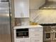 Modern kitchen featuring white cabinets, stainless steel appliances, and a marble backsplash at 541 Earlvine Nw Way, Kennesaw, GA 30152