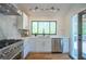 Bright kitchen with modern stainless steel appliances and a view to the outdoor deck at 541 Earlvine Nw Way, Kennesaw, GA 30152
