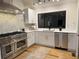 Bright kitchen with stainless steel appliances, light countertops, white cabinets, and wood floors at 541 Earlvine Nw Way, Kennesaw, GA 30152