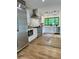 Modern kitchen features stainless steel appliances, white cabinets, and hardwood floors at 541 Earlvine Nw Way, Kennesaw, GA 30152