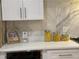 This kitchen features bright counters, attractive jars, and white cabinets at 541 Earlvine Nw Way, Kennesaw, GA 30152