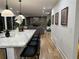 Open-concept kitchen with island seating and living area with fireplace in the background at 541 Earlvine Nw Way, Kennesaw, GA 30152