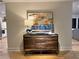 Staged cabinet with modern art and stylish decor in the neutrally-toned living room of the home at 541 Earlvine Nw Way, Kennesaw, GA 30152