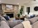 Inviting living room features a stone fireplace and comfortable seating around a square wooden coffee table at 541 Earlvine Nw Way, Kennesaw, GA 30152