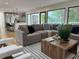 Open-concept living room features a large sectional sofa, hardwood floors, and a modern kitchen at 541 Earlvine Nw Way, Kennesaw, GA 30152