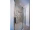 A modern shower with frameless glass doors, and marble-look tile at 541 Earlvine Nw Way, Kennesaw, GA 30152