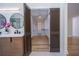 Open bathroom doors lead to a large, organized walk-in closet with custom shelving and storage at 541 Earlvine Nw Way, Kennesaw, GA 30152