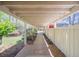 Covered walkway with a brick path, white fence, and views of landscaping at 541 Earlvine Nw Way, Kennesaw, GA 30152