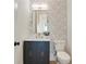 Stylish powder room features modern vanity, a decorative mirror, and patterned wallpaper at 2198 Oakawana Ne Dr, Atlanta, GA 30345