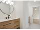 Bathroom featuring a wood vanity, a quartz countertop and a round mirror at 2198 Oakawana Ne Dr, Atlanta, GA 30345