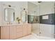 Bright bathroom features a double vanity with marble countertop, brass fixtures and walk-in shower at 2198 Oakawana Ne Dr, Atlanta, GA 30345